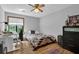 Cozy bedroom with a desk, chair, and dresser next to a window at 2775 Whippoorwill Cir, Duluth, GA 30097