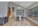 Open dining area with natural light, hardwood floors, seating, and shelving for ample storage at 2775 Whippoorwill Cir, Duluth, GA 30097