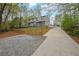 View of the house with a long driveway, retaining wall and landscaping at 2775 Whippoorwill Cir, Duluth, GA 30097