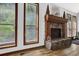Living room stone fireplace, hardwood floors, natural light from windows, and cozy interior at 2775 Whippoorwill Cir, Duluth, GA 30097
