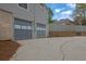 Double garage featuring a concrete driveway, gray doors, and additional parking space at 2775 Whippoorwill Cir, Duluth, GA 30097