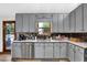 Kitchen view with gray cabinets, stainless appliances, and tile backsplash at 2775 Whippoorwill Cir, Duluth, GA 30097