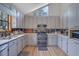 Bright kitchen features light cabinets, modern appliances, and a charming triangular window at 2775 Whippoorwill Cir, Duluth, GA 30097