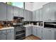 View of the kitchen showing gray cabinets and black stainless steel appliances at 2775 Whippoorwill Cir, Duluth, GA 30097