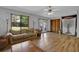 Bright living room with hardwood floors, ceiling fan, and a large window at 2775 Whippoorwill Cir, Duluth, GA 30097