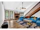 Spacious living room with a stone fireplace, wood floors, and large windows for natural light at 2775 Whippoorwill Cir, Duluth, GA 30097