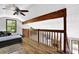 Second-floor loft area with wood trim, ceiling fan, view of living area, and natural light at 2775 Whippoorwill Cir, Duluth, GA 30097