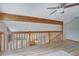 Upper-level loft area with hardwood floors and a wooden beam overlooking the living area at 2775 Whippoorwill Cir, Duluth, GA 30097