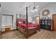 Spacious main bedroom featuring a four-poster bed, ceiling fan, and hardwood floors at 2775 Whippoorwill Cir, Duluth, GA 30097