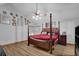 Bright main bedroom featuring a four-poster bed, ceiling fan, and hardwood floors at 2775 Whippoorwill Cir, Duluth, GA 30097