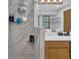 Walk-in shower featuring stone-look tile, glass door, and open shelving at 2775 Whippoorwill Cir, Duluth, GA 30097