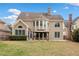 Backyard with a gazebo, expansive lawn, mature trees, and a view of the home's rear elevation at 552 Lawton Bridge Sw Rd, Smyrna, GA 30082