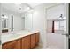 Bathroom featuring dual sinks, wood cabinets, and a view into the adjacent bedroom at 552 Lawton Bridge Sw Rd, Smyrna, GA 30082