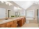 Bathroom with double vanity, large mirrors, a soaking tub, and tiled floors at 552 Lawton Bridge Sw Rd, Smyrna, GA 30082