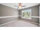 Neutral bedroom with a ceiling fan, a double-hung window, and plush carpeting at 552 Lawton Bridge Sw Rd, Smyrna, GA 30082