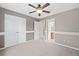Cozy bedroom with neutral walls, plush carpeting, and a view to the ensuite bathroom at 552 Lawton Bridge Sw Rd, Smyrna, GA 30082