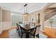 Dining area with hardwood floors, contemporary lighting, and access to a foyer and staircase at 552 Lawton Bridge Sw Rd, Smyrna, GA 30082
