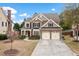 Inviting home with lush landscaping, stone accents, a two-car garage, and a charming red front door at 552 Lawton Bridge Sw Rd, Smyrna, GA 30082