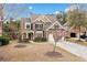 Charming home with stone and siding, landscaped front yard, two-car garage, and a welcoming red front door at 552 Lawton Bridge Sw Rd, Smyrna, GA 30082
