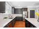 Stylish kitchen featuring quartz counters, dark cabinets, and stainless steel appliances at 552 Lawton Bridge Sw Rd, Smyrna, GA 30082