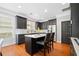 Modern kitchen with a center island, dark cabinets, stainless steel appliances and hardwood floors at 552 Lawton Bridge Sw Rd, Smyrna, GA 30082