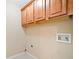 Functional laundry area with wooden cabinets for storage and easy access to plumbing at 552 Lawton Bridge Sw Rd, Smyrna, GA 30082