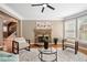 Inviting living room featuring stone fireplace, hardwood floors, and large bright windows at 552 Lawton Bridge Sw Rd, Smyrna, GA 30082