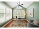 Bright office with a ceiling fan, many windows and a modern glass desk at 552 Lawton Bridge Sw Rd, Smyrna, GA 30082