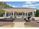 View of the covered picnic tables and grill with a tennis court in the background on a sunny day at 552 Lawton Bridge Sw Rd, Smyrna, GA 30082