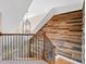 Stairwell with iron railings, wood stairs, and decorative wood accent wall at 552 Lawton Bridge Sw Rd, Smyrna, GA 30082