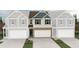 New construction townhome with charming exterior, a two-car garage, and a brick facade at 6350 Towhee Way, Morrow, GA 30260