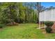 Lush backyard with manicured lawn and colorful flowering shrubs and a small brick wall at 2350 Powers Ferry Se Dr, Marietta, GA 30067