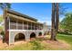 Expansive backyard with a screened porch and a brick-supported foundation, ideal for outdoor enjoyment at 2350 Powers Ferry Se Dr, Marietta, GA 30067
