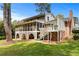 Spacious backyard with a screened porch, brick foundation, and stairs leading to the well-maintained upper level at 2350 Powers Ferry Se Dr, Marietta, GA 30067