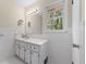 Well-maintained bathroom with white tile, vanity with storage, and framed mirror at 2350 Powers Ferry Se Dr, Marietta, GA 30067