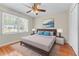 Bedroom with large window, a neutral-toned bed, and hardwood floors at 2350 Powers Ferry Se Dr, Marietta, GA 30067