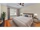 Neutral bedroom with large window, hardwood floors, and neutral colored walls at 2350 Powers Ferry Se Dr, Marietta, GA 30067