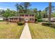 Charming brick home with a well-maintained lawn and traditional landscaping at 2350 Powers Ferry Se Dr, Marietta, GA 30067