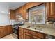 Updated kitchen featuring granite countertops, stainless steel appliances, and wood cabinets at 2350 Powers Ferry Se Dr, Marietta, GA 30067