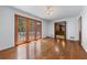 Spacious living room with hardwood floors, glass doors to deck, and entry to kitchen at 2350 Powers Ferry Se Dr, Marietta, GA 30067