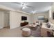 Comfortable living room featuring neutral walls, carpet, ceiling fans, and a cozy seating area with a television at 2350 Powers Ferry Se Dr, Marietta, GA 30067