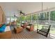 Relaxing screened porch with seating, ceiling fans, and porch swing overlooking the backyard at 2350 Powers Ferry Se Dr, Marietta, GA 30067