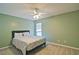 This is a serene bedroom with light-green walls, plush carpet and a ceiling fan at 4095 Stillwater Dr, Duluth, GA 30096
