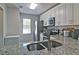 Bright kitchen with granite countertops, stainless steel appliances, and white cabinets at 4095 Stillwater Dr, Duluth, GA 30096