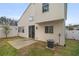 View of the home's backyard featuring a concrete patio, neutral siding, and white fencing at 612 Windcroft Nw Cir, Acworth, GA 30101