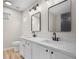 Bright bathroom featuring dual sinks, modern fixtures, and a sleek vanity with white cabinets at 612 Windcroft Nw Cir, Acworth, GA 30101
