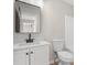 A bathroom with a sleek white vanity and modern fixtures and a granite countertop at 612 Windcroft Nw Cir, Acworth, GA 30101