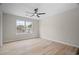 Bright bedroom with hardwood floors, ceiling fan, and a large window at 612 Windcroft Nw Cir, Acworth, GA 30101