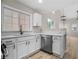 Well-lit kitchen boasts white cabinets, stainless steel appliances, and granite countertops at 612 Windcroft Nw Cir, Acworth, GA 30101