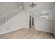 Open-concept living area featuring hardwood floors, modern light fixture, and a staircase at 612 Windcroft Nw Cir, Acworth, GA 30101